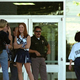 An armed police officer stands guard over a group of Columbine
cheerleaders.